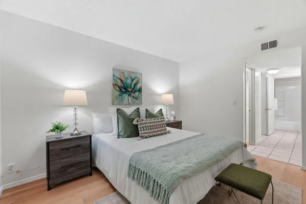 a bedroom with a bed and a lamp on table