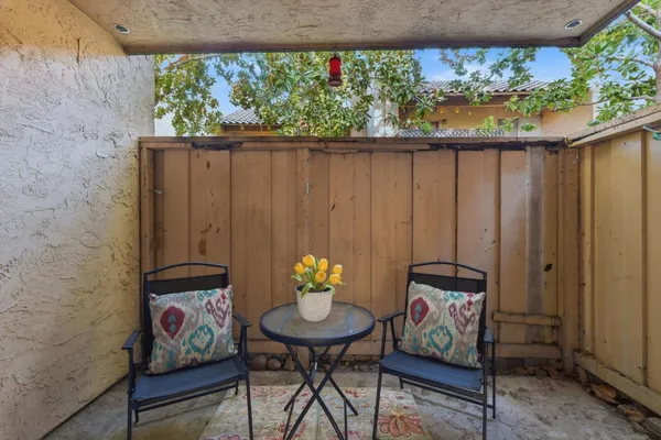 a view of a balcony with chairs and a table