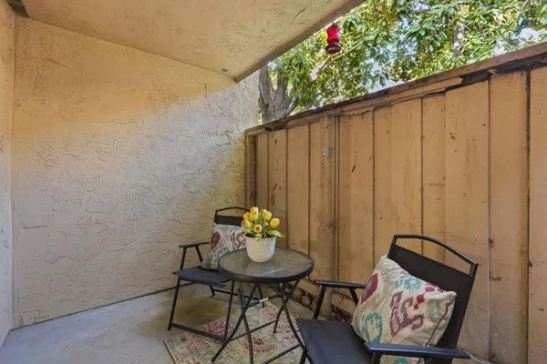 a balcony with table and chairs