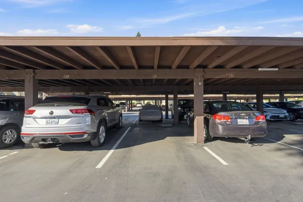 a view of a cars park in front of retail shop