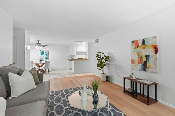 a living room with furniture and wooden floor