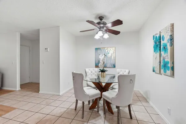 a view of a dining room with furniture and chandelier