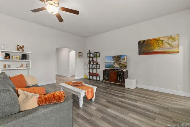 a living room with furniture and a wooden floor