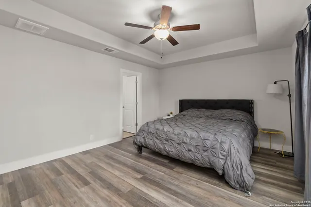 a bedroom with a bed and a ceiling fan