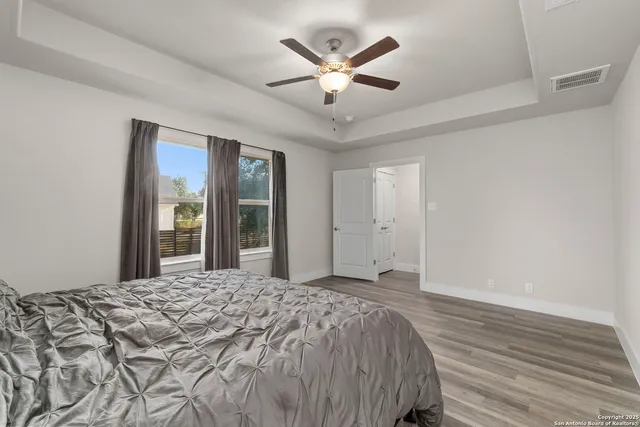 a bedroom with a large bed and a large window