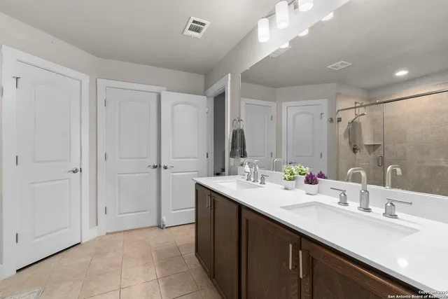a bathroom with a sink double vanity and a mirror