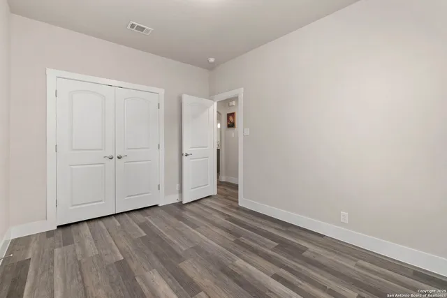 an empty room with wooden floor