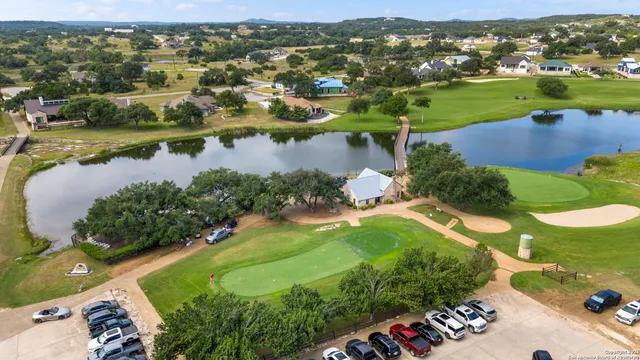 an aerial view of residential houses with outdoor space and river