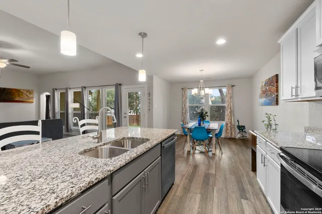 a large kitchen with stainless steel appliances granite countertop a lot of counter space