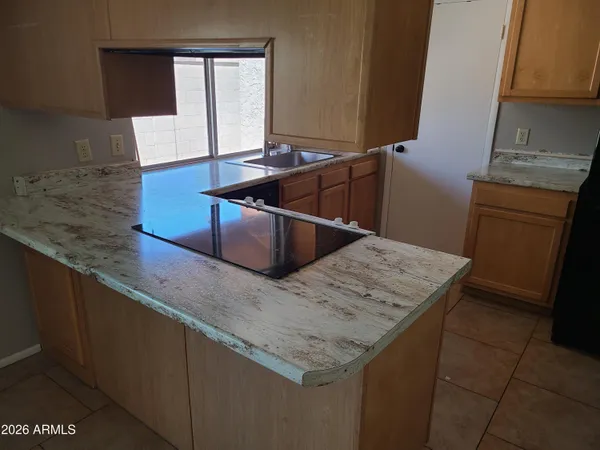a kitchen with granite countertop a sink and a stove