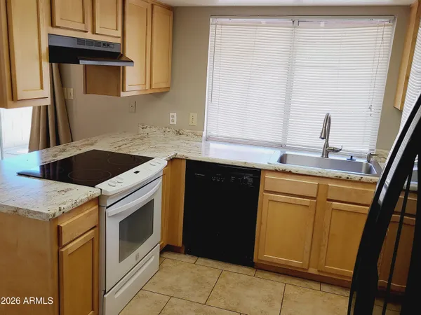a kitchen with a sink and a stove top oven