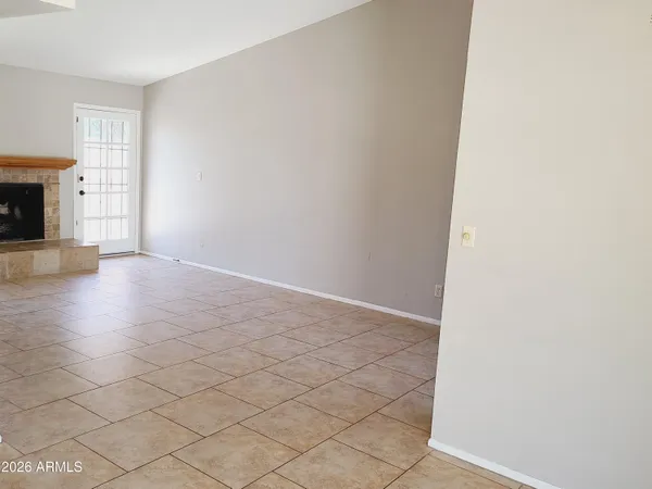an empty room with wooden floor and fireplace