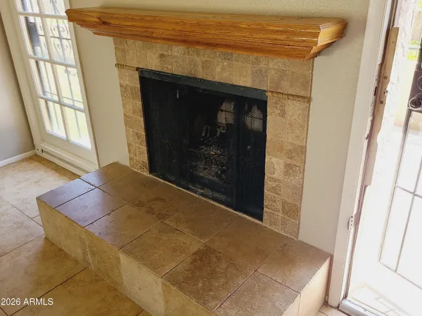 a living room with a fireplace and next to a window