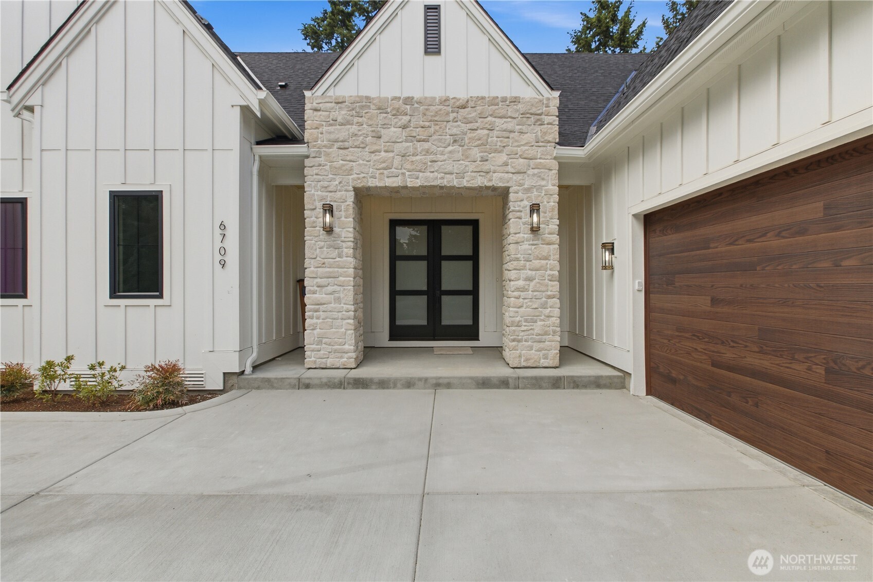 6709 254th Street East Graham, WA 98338 - Photo 4 of 40 a front view of a house with white doors