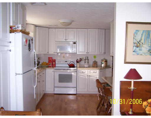 31 Irving Road Natick, MA 01760 - Photo 2 of 12 a kitchen with a refrigerator and white cabinets