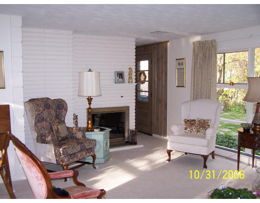31 Irving Road Natick, MA 01760 - Photo 4 of 12 a living room with furniture and a fireplace