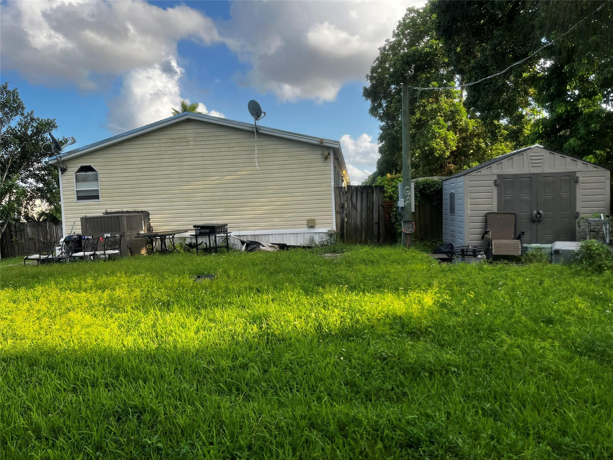 Undisclosed Address Davie, FL 33325 - Photo 4 of 19 a backyard of a house with lots of green space