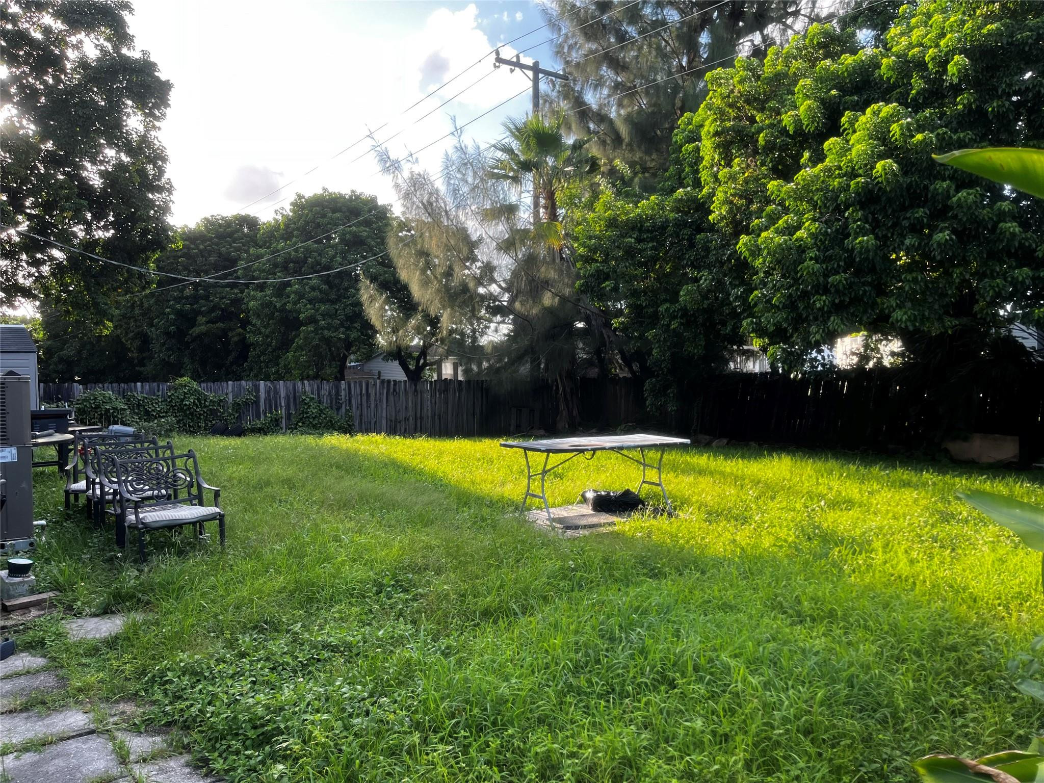 Undisclosed Address Davie, FL 33325 - Photo 5 of 19 a view of a backyard with swimming pool