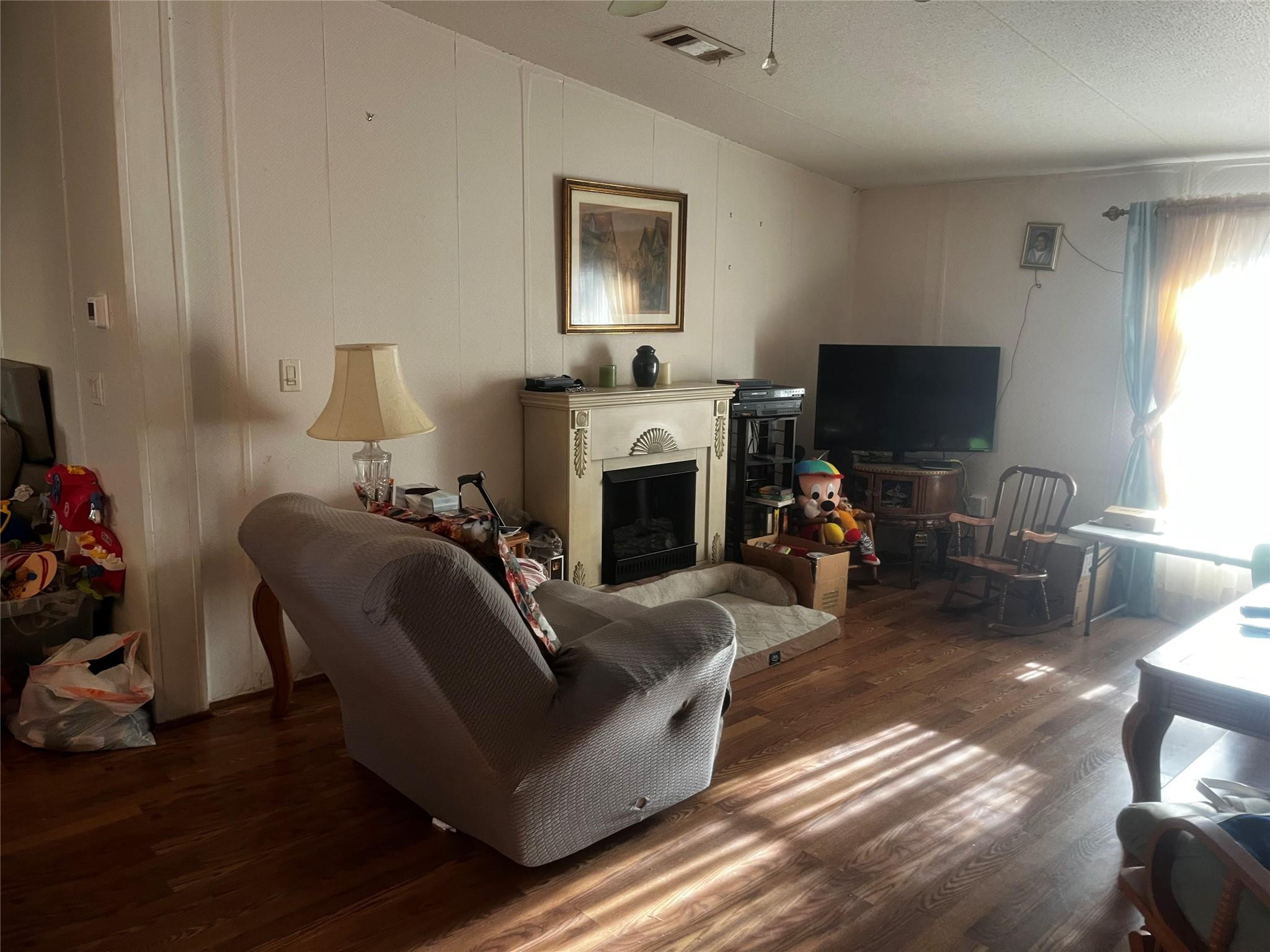 Undisclosed Address Davie, FL 33325 - Photo 8 of 19 a living room with furniture a fireplace and a flat screen tv