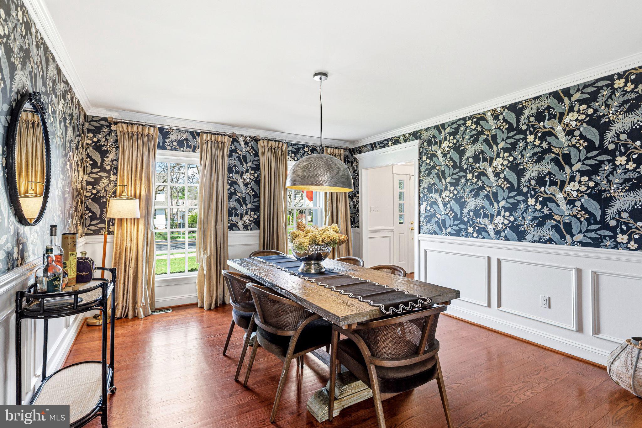 380 Kings Highway West Haddonfield, NJ 08033 - Photo 12 of 50 a dining room with wooden floor a chandelier a wooden table and chairs