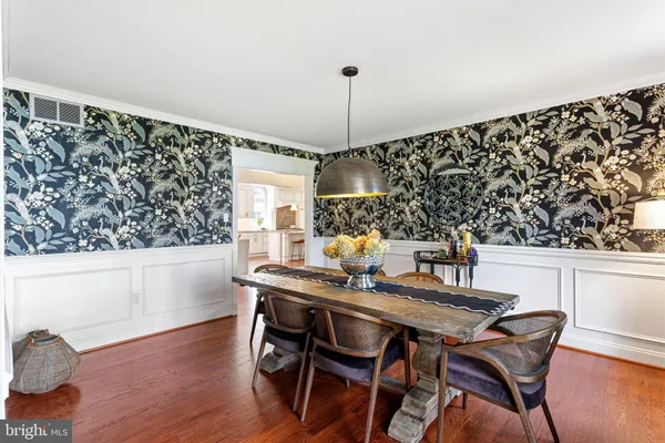 a dining room with furniture and wooden floor