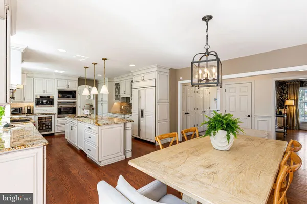a kitchen with a table and chairs in it