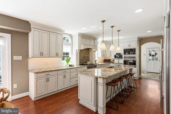 a kitchen with stainless steel appliances granite countertop a stove and cabinets