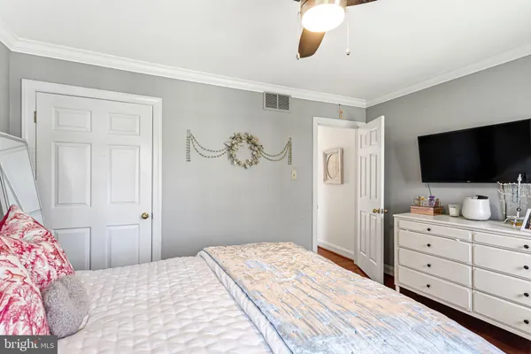 a bedroom with a bed and a flat screen tv in it