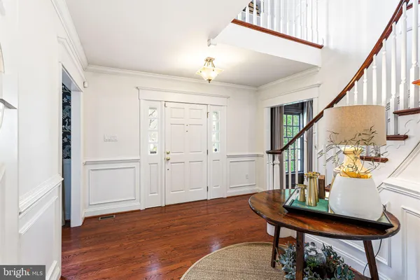 a view of a livingroom with furniture wooden floor and front door