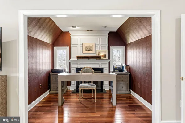 a dining room with furniture and wooden floor