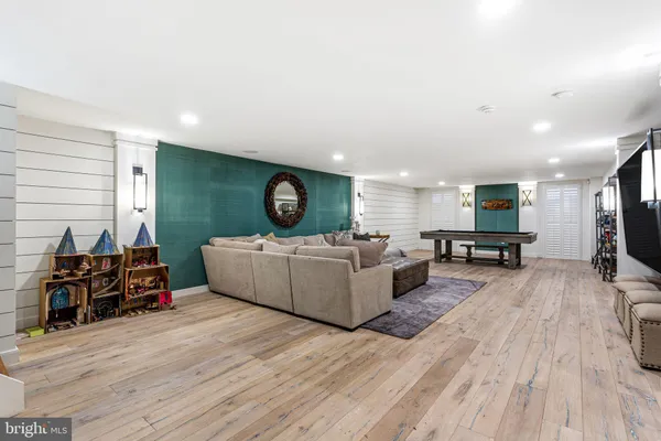 a room with pool table and windows