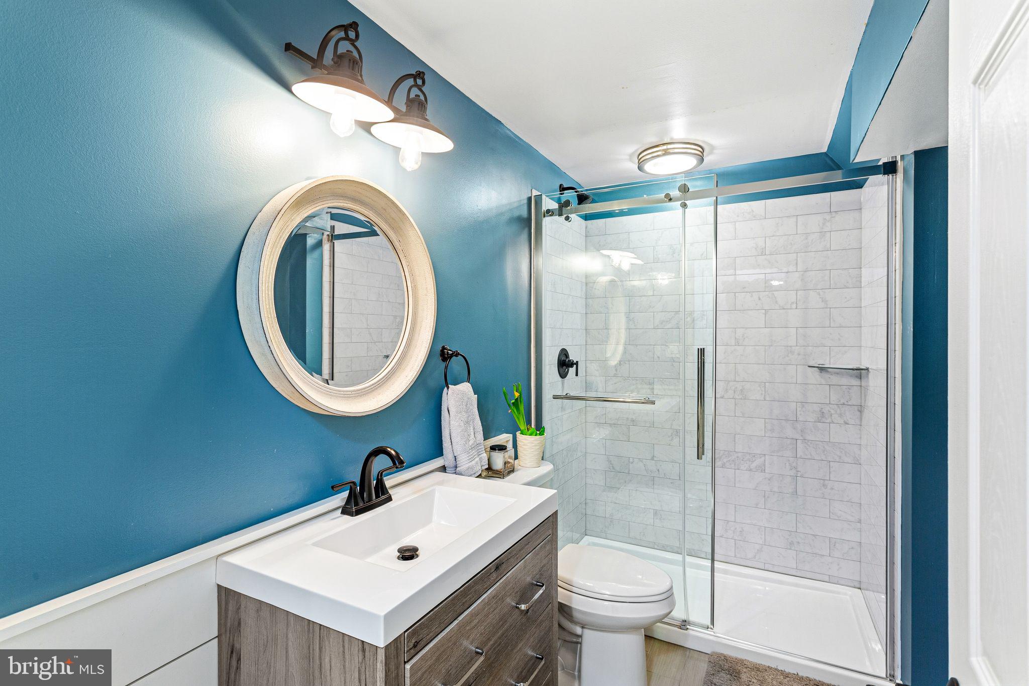 380 Kings Highway West Haddonfield, NJ 08033 - Photo 44 of 50 a bathroom with a sink a toilet and a mirror