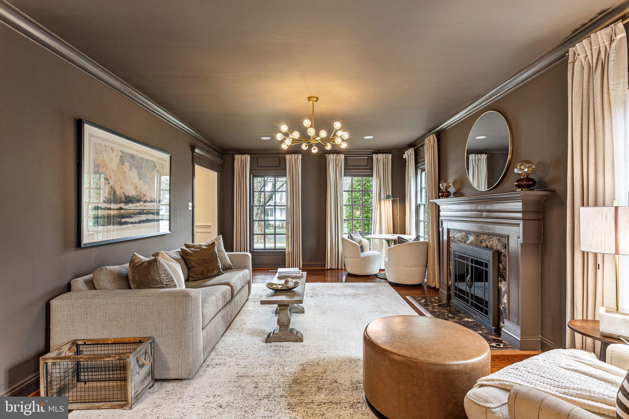 380 Kings Highway West Haddonfield, NJ 08033 - Photo 5 of 50 a living room with furniture a fireplace and a chandelier