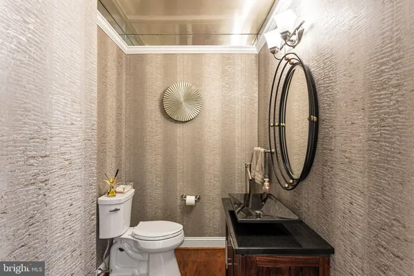 a bathroom with a sink a toilet and a mirror