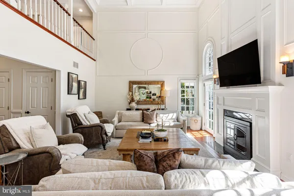 a living room with fireplace a flat screen tv and a fireplace