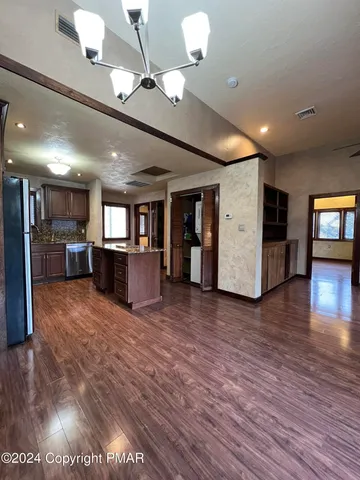 a kitchen with stainless steel appliances granite countertop a stove and a refrigerator