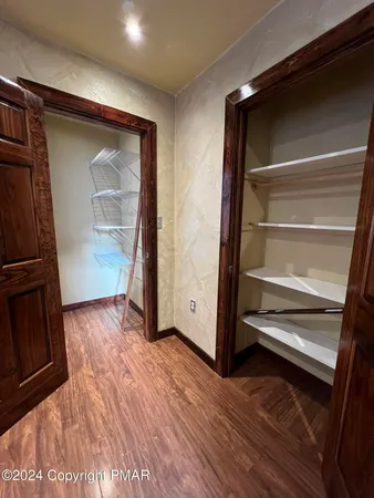 a view of a room with wooden floor and window
