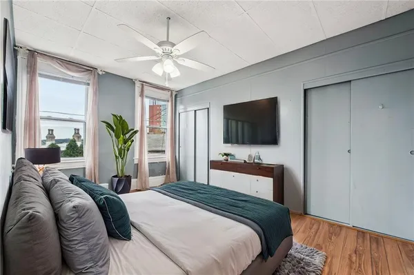 a bathroom with a sink a toilet a mirror a bathtub and shower