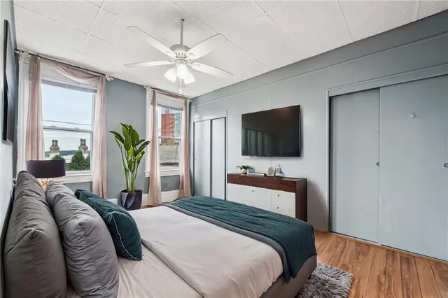 a bathroom with a sink a toilet a mirror a bathtub and shower