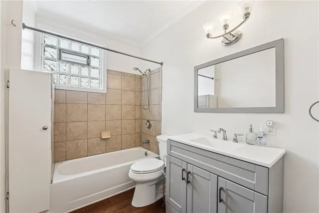 a bedroom with a bed and a chandelier fan
