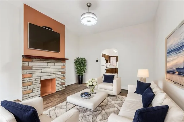 a living room with furniture a fireplace and a flat screen tv