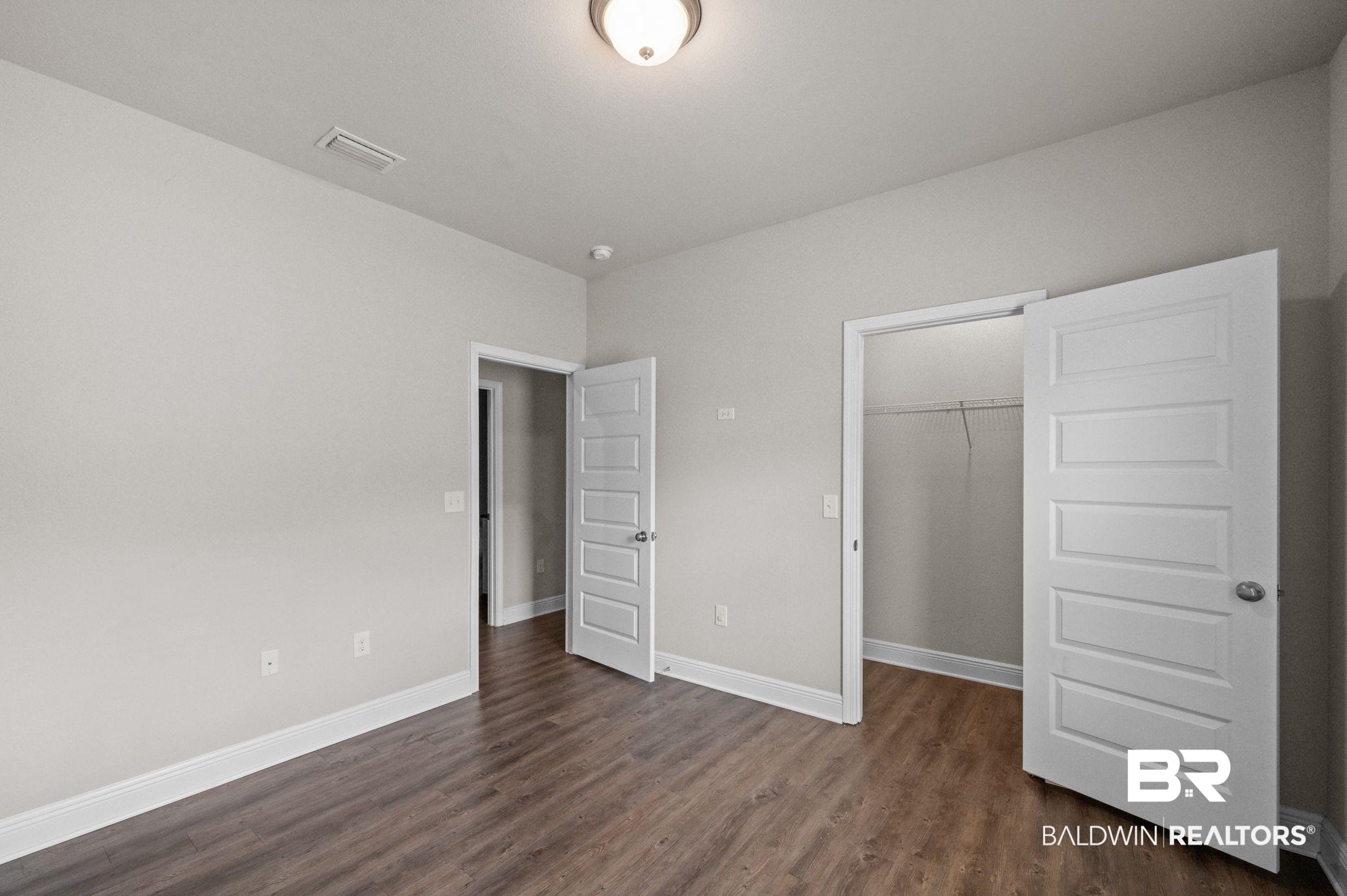 2074 Bourbon Street Foley, AL 36535 - Photo 30 of 46 Unfurnished bedroom with dark hardwood / wood-style floors and a closet