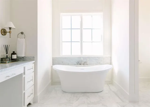 a white bath tub sitting next to a white sink