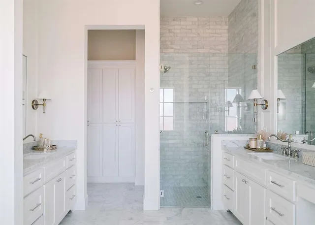 a bathroom with a granite countertop sink a mirror and a shower