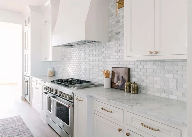 a kitchen with granite countertop a stove and a sink