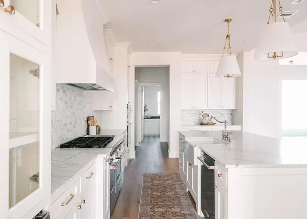 a kitchen with a sink stove and cabinets