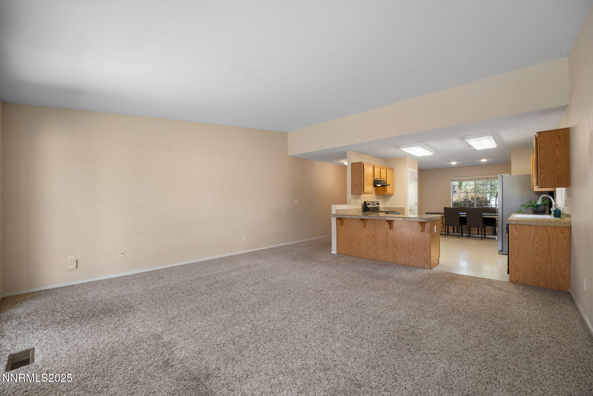 9770 Brightridge Drive Reno, NV 89506 - Photo 11 of 43 a view of a kitchen with furniture and a flat screen tv