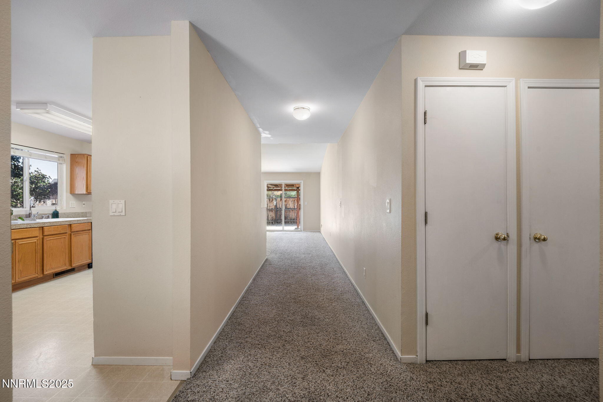 9770 Brightridge Drive Reno, NV 89506 - Photo 2 of 43 a view of a hallway with a livingroom and a bathroom with sink