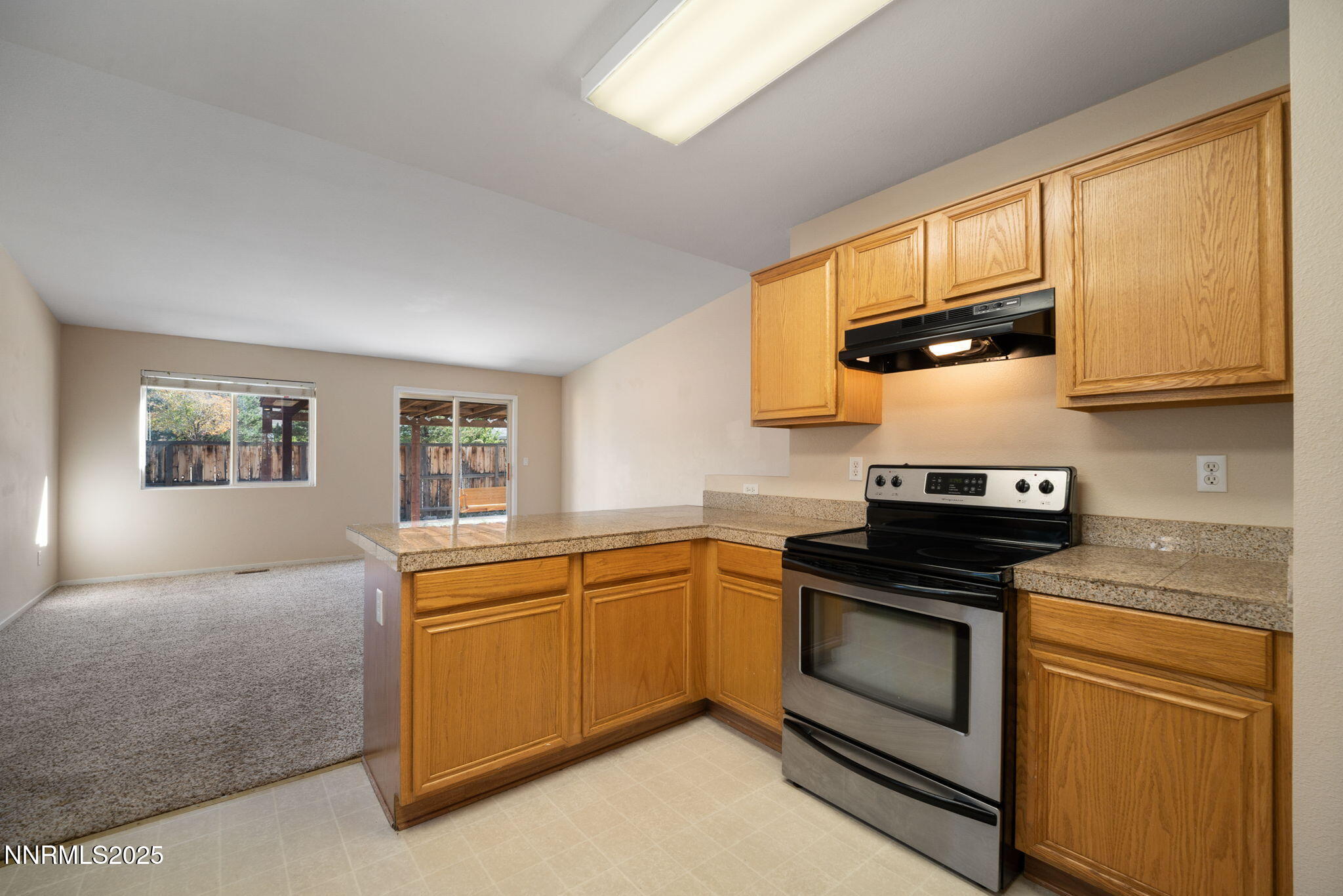 9770 Brightridge Drive Reno, NV 89506 - Photo 4 of 43 a kitchen with stainless steel appliances granite countertop a stove a sink and a microwave