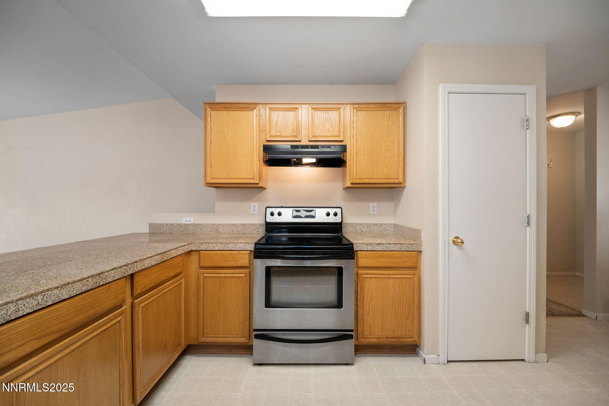 9770 Brightridge Drive Reno, NV 89506 - Photo 5 of 43 a kitchen with stainless steel appliances granite countertop white cabinets and a stove